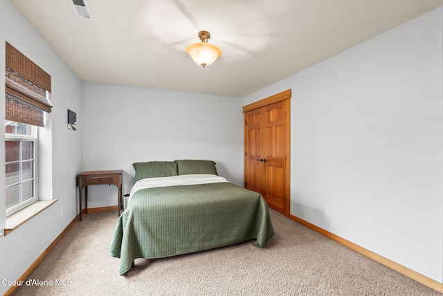 bedroom with baseboards, carpet flooring, and visible vents