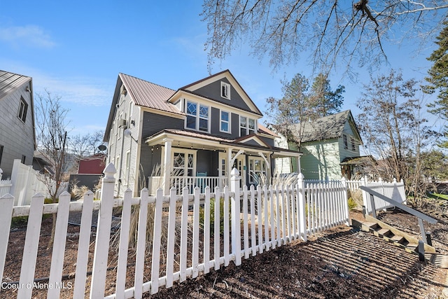 516 E Indiana Ave, Coeur Dalene, ID 83814 - view of front facade with metal roof, a fenced front yard, and covered porch