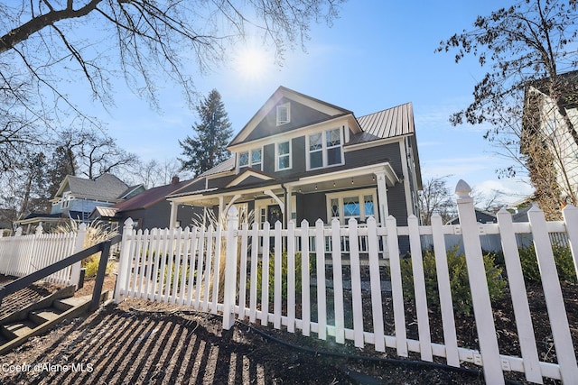 516 E Indiana Ave, Coeur Dalene, ID 83814 - view of front facade with a porch, metal roof, and a fenced front yard