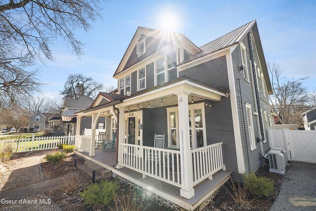 516 E Indiana Ave, Coeur Dalene, ID 83814 - view of front of house with a gate, fence, a porch, ac unit, and metal roof