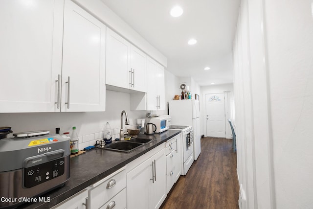 516 E Indiana Ave, Coeur Dalene, ID 83814 - kitchen featuring dark countertops, a sink, white appliances, white cabinetry, and recessed lighting