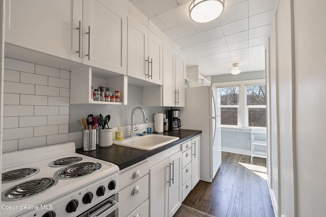 516 E Indiana Ave, Coeur Dalene, ID 83814 - kitchen featuring white cabinets, dark wood-style floors, a sink, dark countertops, and white appliances