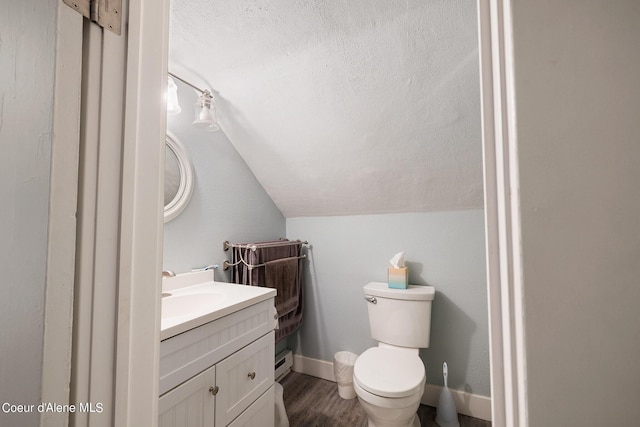 516 E Indiana Ave, Coeur Dalene, ID 83814 - half bath with a baseboard radiator, toilet, wood finished floors, vanity, and lofted ceiling