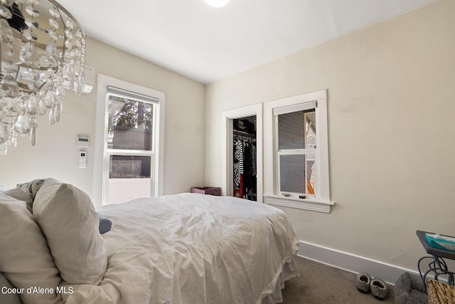 516 E Indiana Ave, Coeur Dalene, ID 83814 - bedroom with dark carpet, a spacious closet, and baseboards