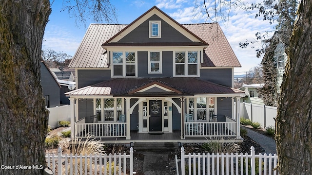 516 E Indiana Ave, Coeur Dalene, ID 83814 - view of front of property with metal roof, a fenced front yard, and covered porch