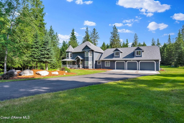 3825 E English Point Rd, Hayden, ID 83835 - victorian-style house featuring driveway, a garage, a front yard, and a porch