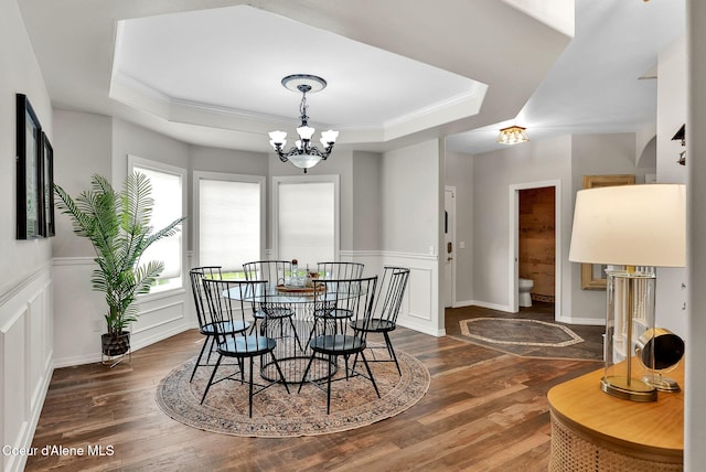 3825 E English Point Rd, Hayden, ID 83835 - dining space with a tray ceiling, wood finished floors, a chandelier, a wainscoted wall, and ornamental molding