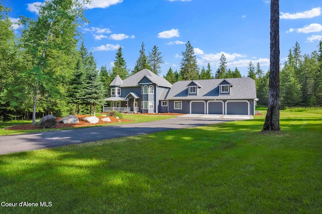 3825 E English Point Rd, Hayden, ID 83835 - view of front of house with driveway, a front lawn, and a garage