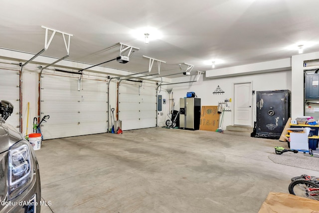 3825 E English Point Rd, Hayden, ID 83835 - garage with a garage door opener, stainless steel fridge with ice dispenser, and electric panel