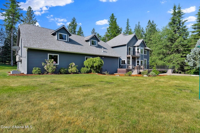 3825 E English Point Rd, Hayden, ID 83835 - back of property with a lawn, a shingled roof, a wooden deck, and a balcony