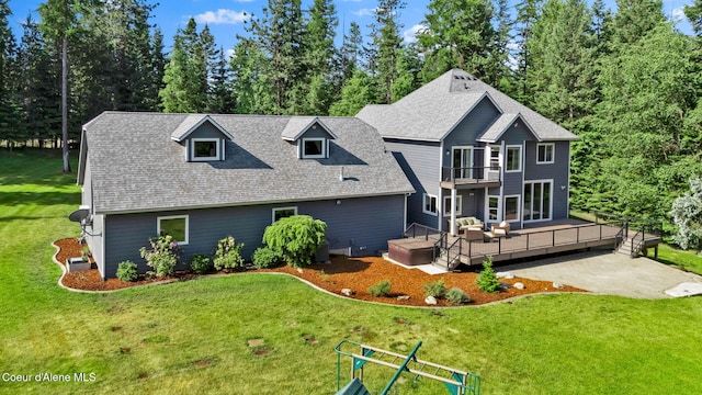 3825 E English Point Rd, Hayden, ID 83835 - back of house with a balcony, a deck, a lawn, a shingled roof, and a patio area
