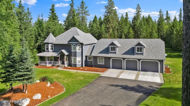 3825 E English Point Rd, Hayden, ID 83835 - view of front of house with driveway, covered porch, a shingled roof, and a front lawn