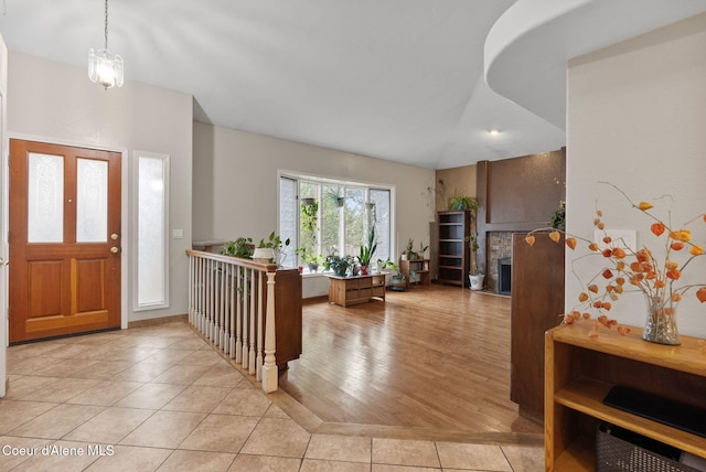 entryway featuring a fireplace and light tile patterned floors