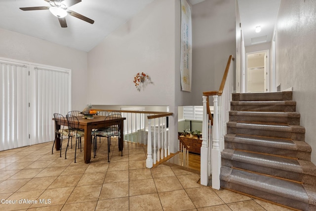 dining area featuring lofted ceiling, a ceiling fan, visible vents, and light tile patterned floors