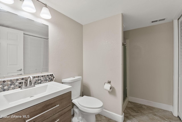 bathroom with a stall shower, toilet, visible vents, a closet, and vanity