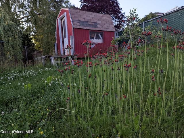 view of shed with fence