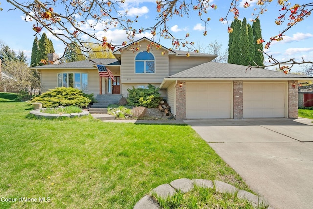 split level home featuring brick siding, a front lawn, driveway, and a garage