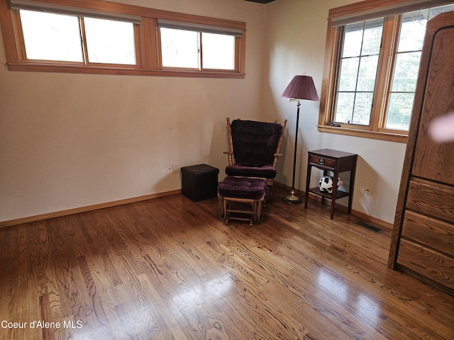 11268 N Friar Dr, Hayden, ID 83835 - living area featuring wood finished floors, visible vents, and baseboards