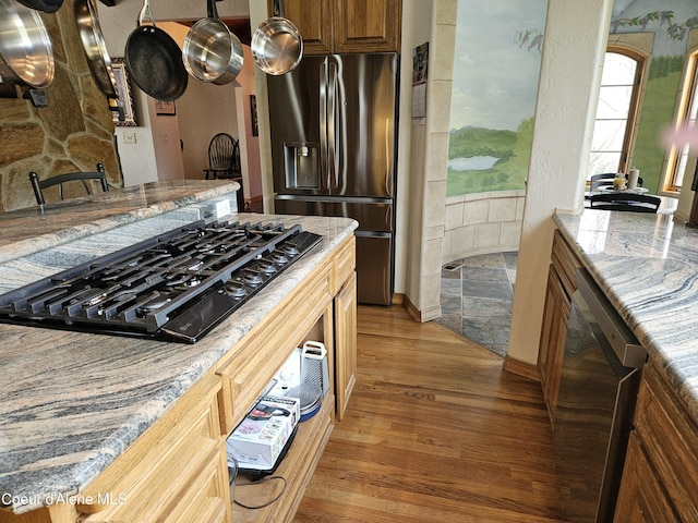 11268 N Friar Dr, Hayden, ID 83835 - kitchen featuring light stone countertops, baseboards, light wood-style floors, and appliances with stainless steel finishes