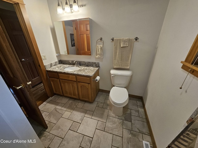 11268 N Friar Dr, Hayden, ID 83835 - bathroom featuring toilet, visible vents, baseboards, a chandelier, and vanity