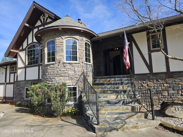 11268 N Friar Dr, Hayden, ID 83835 - tudor house featuring stone siding, stairs, and stucco siding