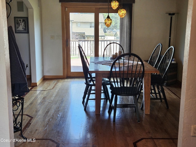 11268 N Friar Dr, Hayden, ID 83835 - dining space with arched walkways, plenty of natural light, baseboards, and wood finished floors