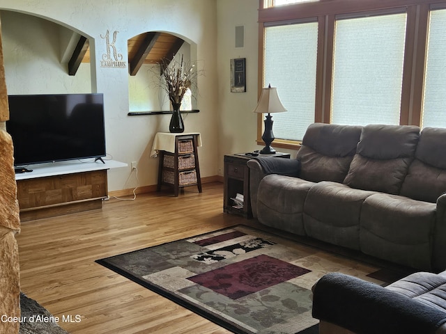 11268 N Friar Dr, Hayden, ID 83835 - living room featuring arched walkways, wood finished floors, and baseboards