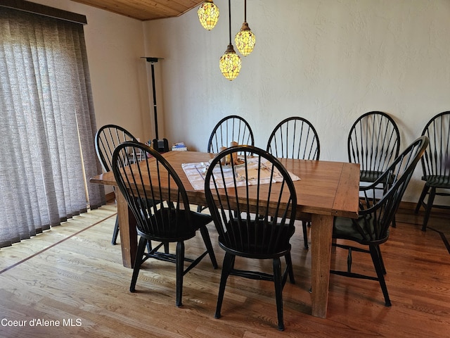 11268 N Friar Dr, Hayden, ID 83835 - dining area featuring wood finished floors, wooden ceiling, and a textured wall