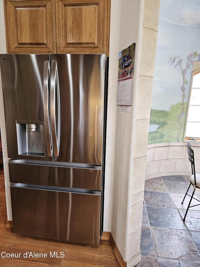 11268 N Friar Dr, Hayden, ID 83835 - interior details featuring brown cabinetry, baseboards, and stainless steel fridge with ice dispenser