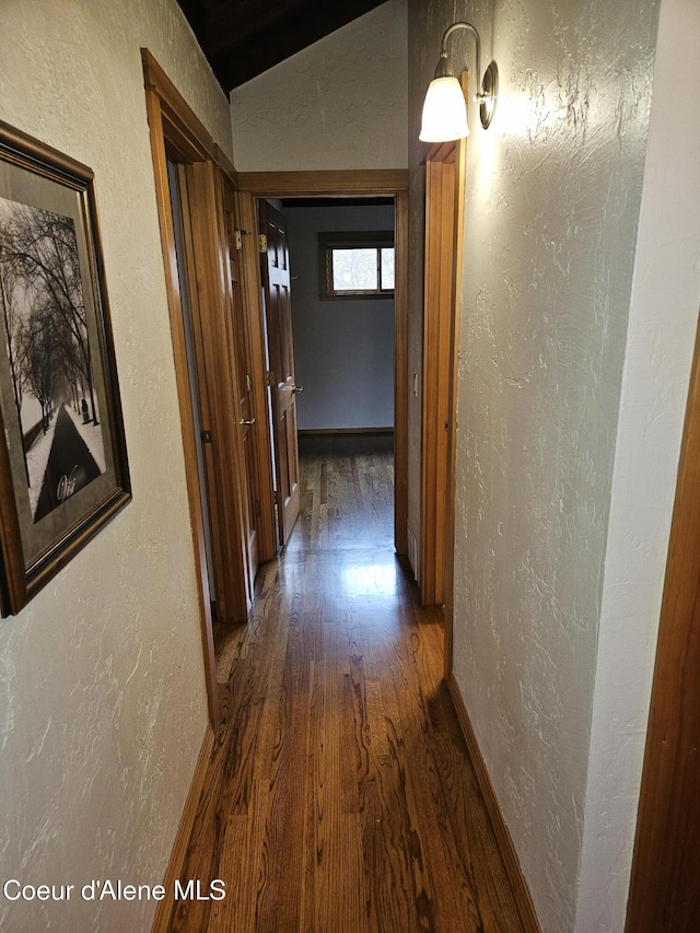 11268 N Friar Dr, Hayden, ID 83835 - hallway with dark wood finished floors, a textured wall, and baseboards