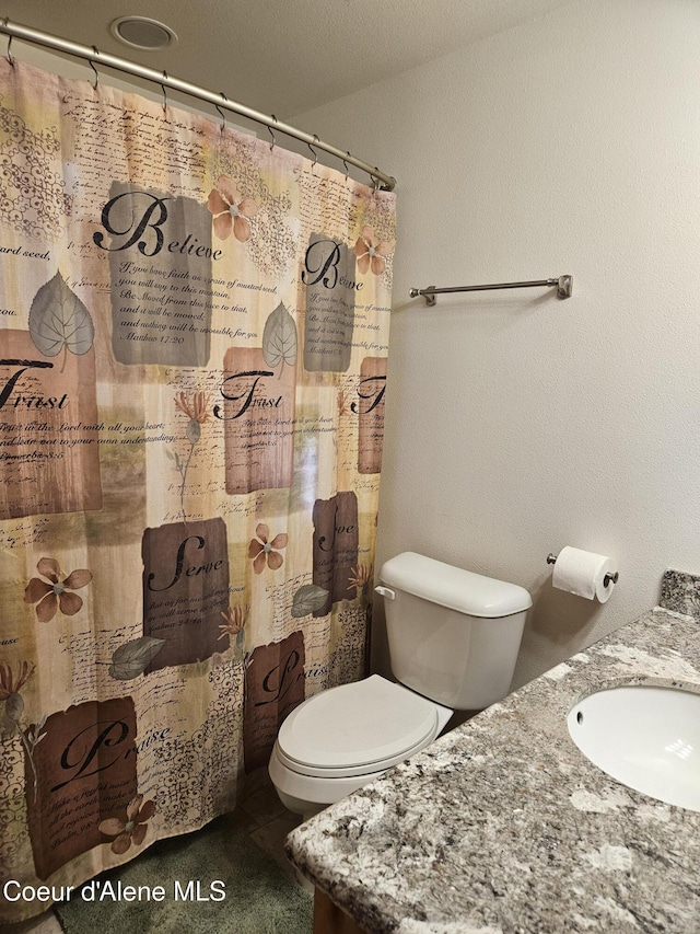 11268 N Friar Dr, Hayden, ID 83835 - bathroom with toilet, tile patterned floors, a sink, and curtained shower