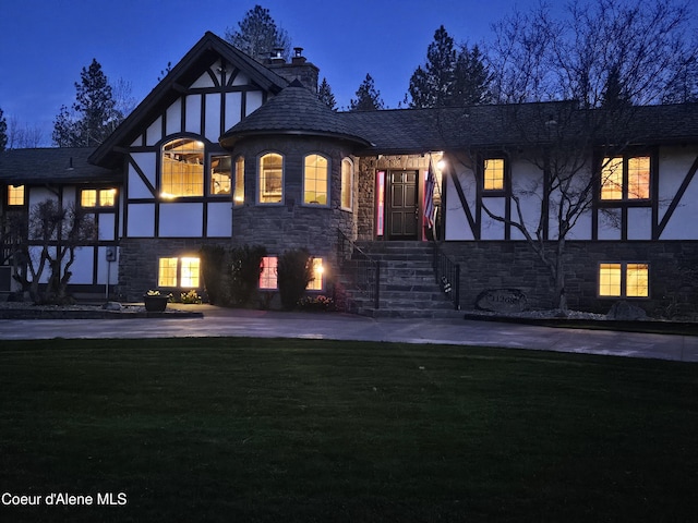 11268 N Friar Dr, Hayden, ID 83835 - tudor home with a front lawn, stone siding, a chimney, and stucco siding