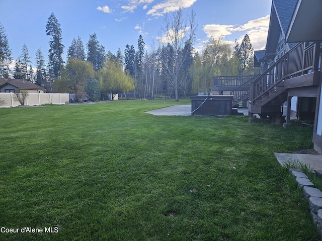 11268 N Friar Dr, Hayden, ID 83835 - view of yard featuring a patio area, a hot tub, stairs, and fence