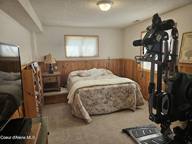 11268 N Friar Dr, Hayden, ID 83835 - bedroom with a wainscoted wall, a textured ceiling, wooden walls, and carpet
