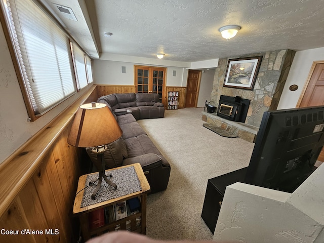 11268 N Friar Dr, Hayden, ID 83835 - living area featuring a textured ceiling, wainscoting, carpet floors, wood walls, and visible vents
