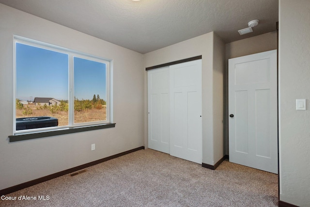 818 Sawbuck Rd, Spirit Lake, ID 83869 - unfurnished bedroom featuring carpet floors, baseboards, and a closet