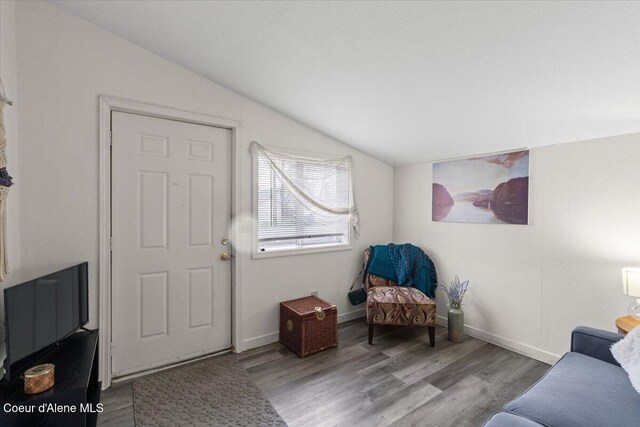 1515 E Elm Ave, Coeur Dalene, ID 83814 - living area featuring vaulted ceiling, wood finished floors, and baseboards
