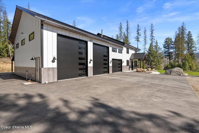 329 N Healing Dr, Blanchard, ID 83804 - view of property exterior with board and batten siding and a detached garage