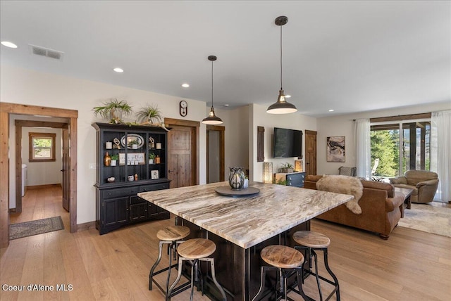 329 N Healing Dr, Blanchard, ID 83804 - kitchen featuring recessed lighting, a kitchen bar, light wood-style floors, and visible vents