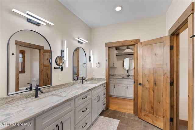 329 N Healing Dr, Blanchard, ID 83804 - full bathroom with double vanity, toilet, and a sink