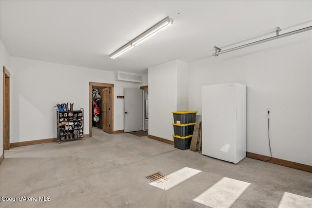 329 N Healing Dr, Blanchard, ID 83804 - garage with baseboards and freestanding refrigerator