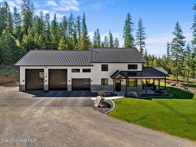 329 N Healing Dr, Blanchard, ID 83804 - view of front of property with driveway, a front yard, metal roof, and covered porch
