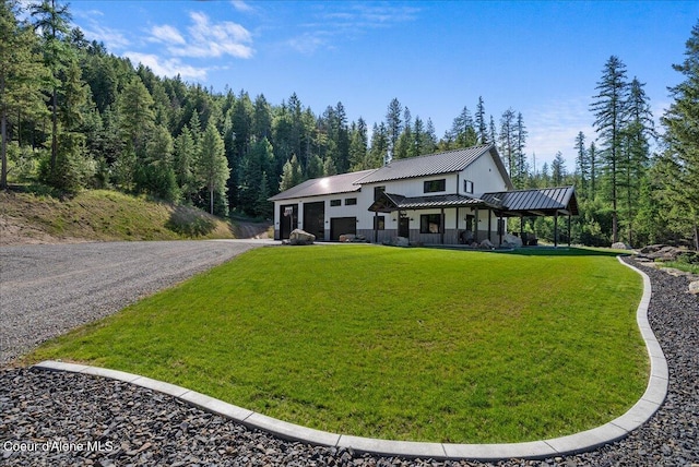 329 N Healing Dr, Blanchard, ID 83804 - view of front of home with a front yard, driveway, a standing seam roof, and metal roof