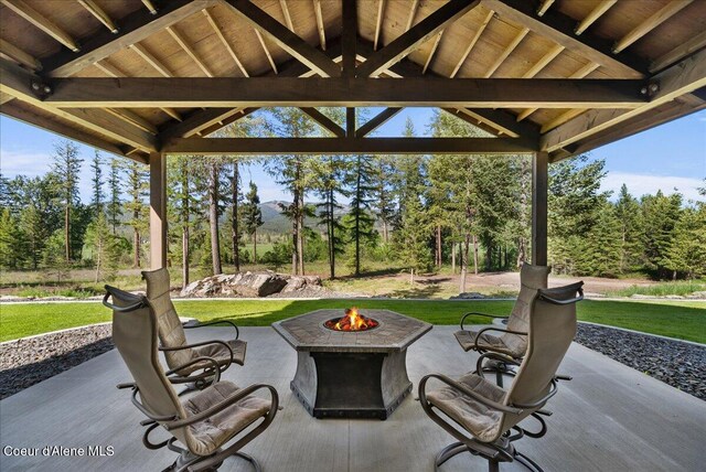 329 N Healing Dr, Blanchard, ID 83804 - view of patio with an outdoor fire pit and view of wooded area