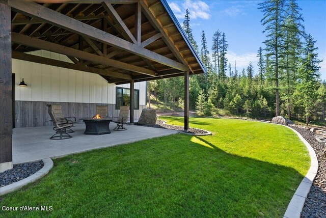 329 N Healing Dr, Blanchard, ID 83804 - view of grassy yard featuring a fire pit and a patio