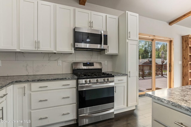 kitchen featuring dark wood-style floors, white cabinetry, appliances with stainless steel finishes, and decorative backsplash