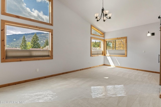 spare room featuring baseboards, a notable chandelier, carpet, and high vaulted ceiling