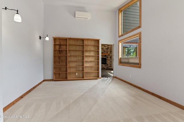 4110 Burns Ct, Sandpoint, ID 83864 - carpeted empty room with baseboards, a wall mounted air conditioner, and a fireplace