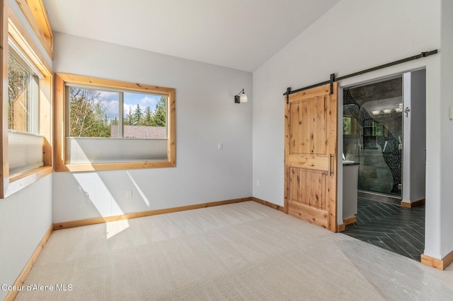 4110 Burns Ct, Sandpoint, ID 83864 - spare room with baseboards, a barn door, and carpet