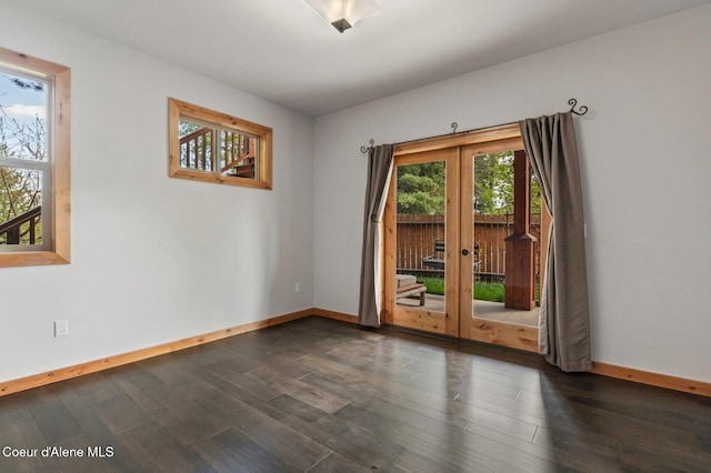 unfurnished room with baseboards, dark wood finished floors, and french doors